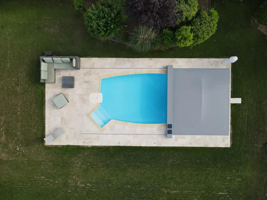 Aerial view of an automatic safety pool cover on a freeform pool