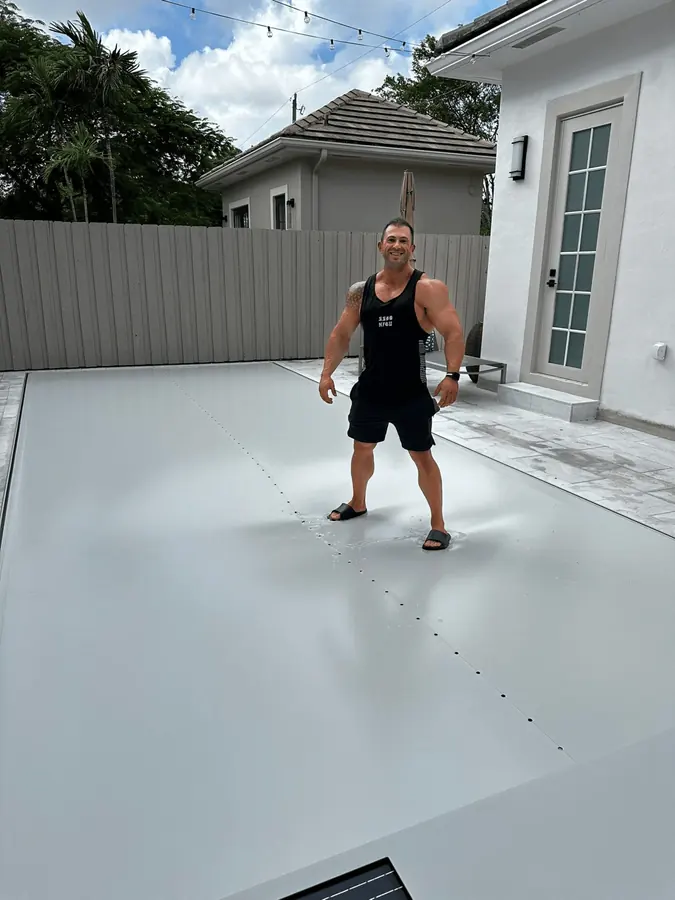 Adult standing safely on a closed manual safety pool cover