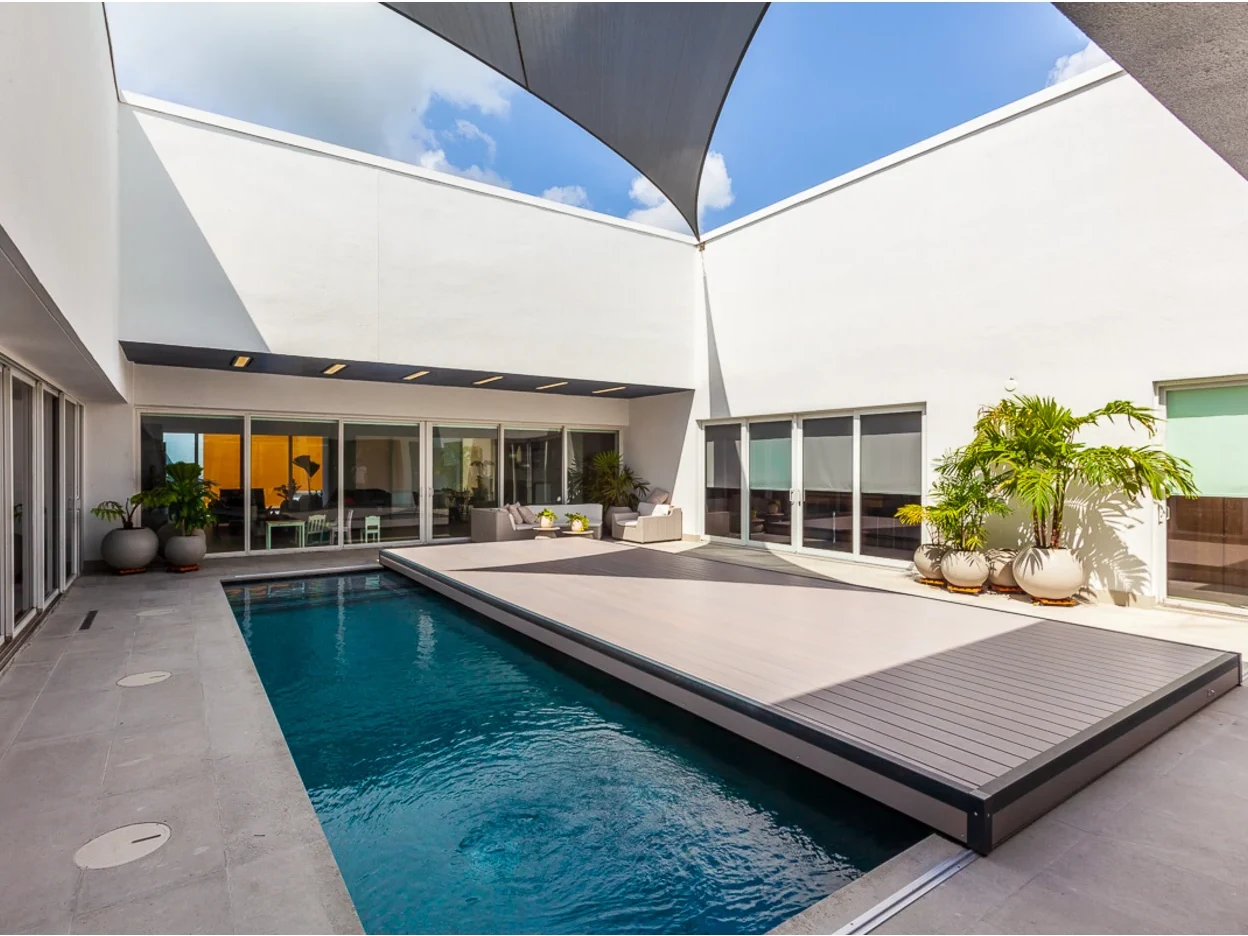 Modern courtyard pool with an S-LIDE sliding deck cover