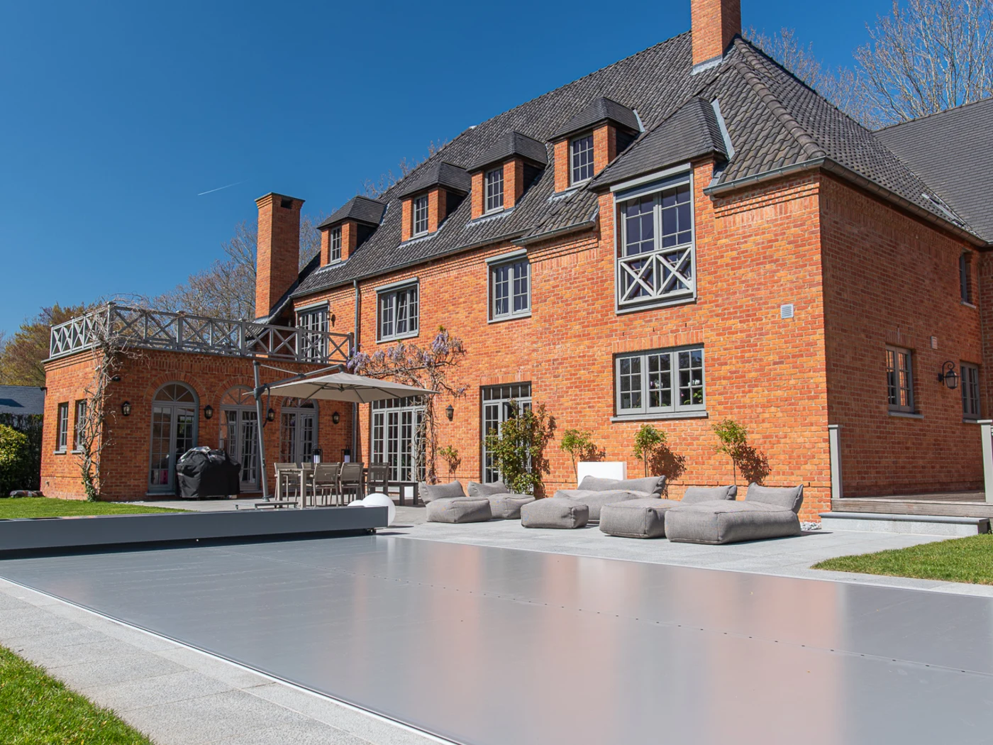 Elegant estate backyard with a fully closed pool cover