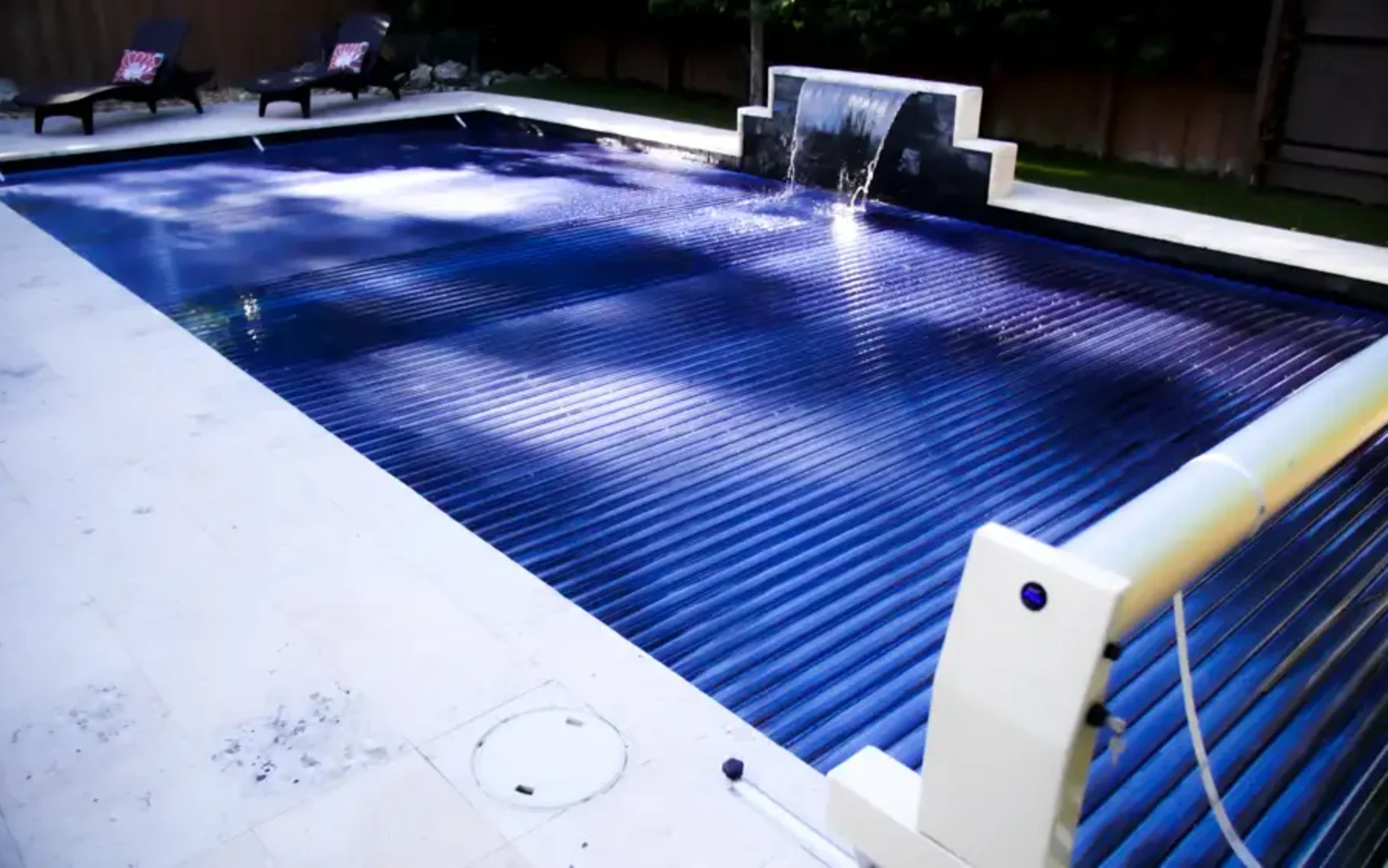 S-ROLL cover extended across a pool to seal in water and reduce evaporation